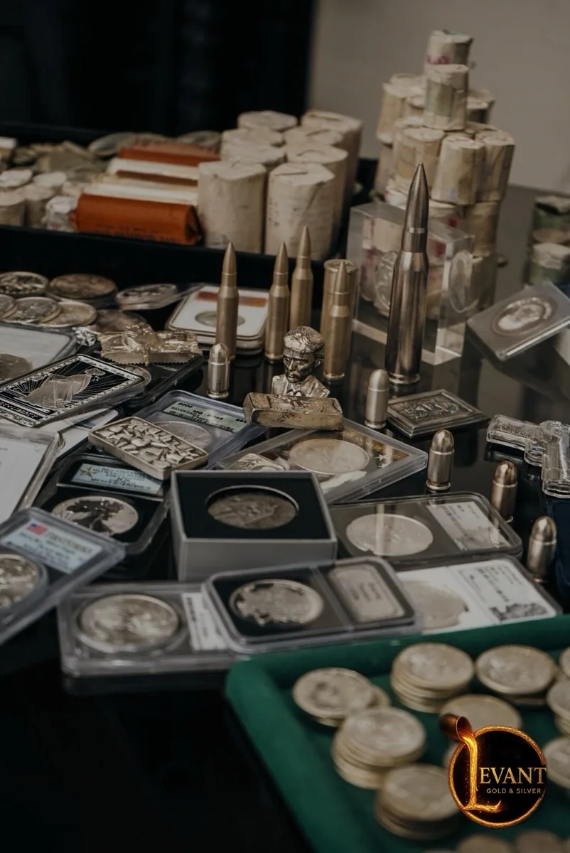 Coins, bars, and slabs in a display case at Levant Gold & Silver